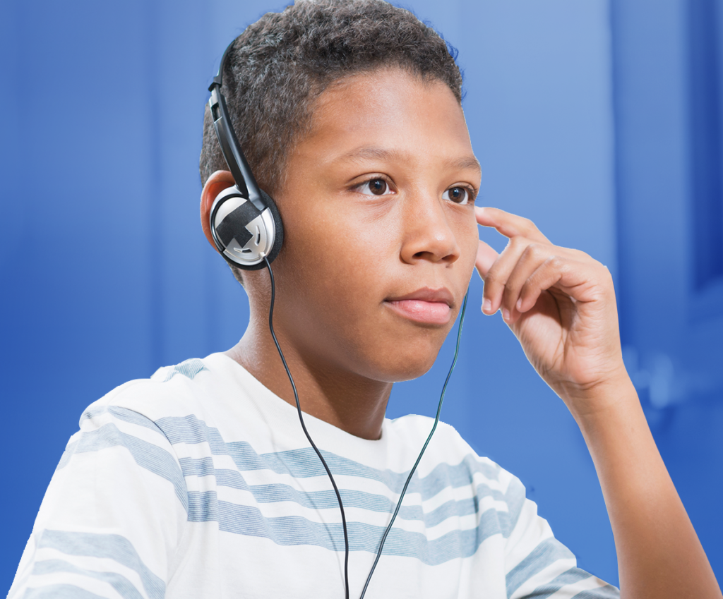 Middle grade boy with headphones on..